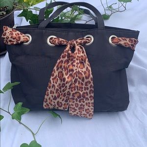 Black purse with leopard-print accent ribbon